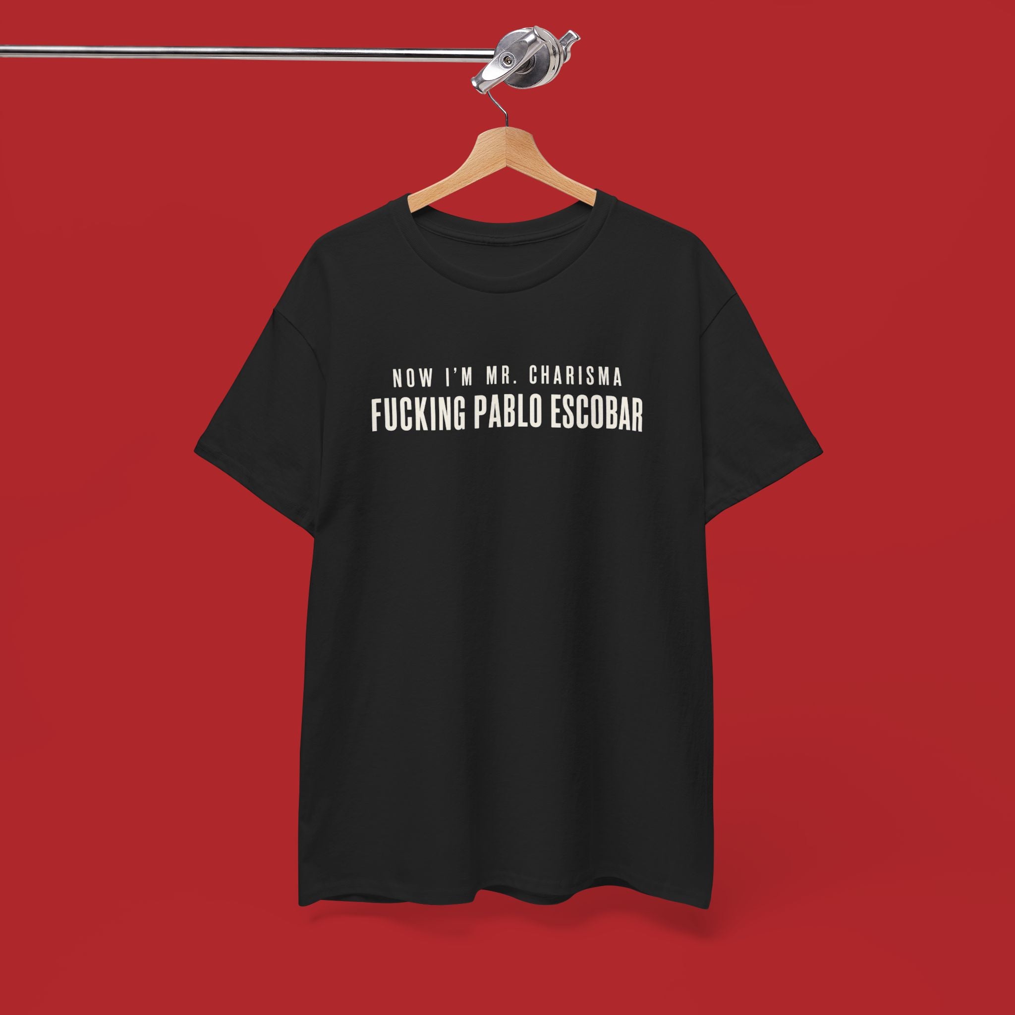 Black cotton T-shirt featuring bold white text "Now I'm Mr. Charisma Fucking Pablo Escobar" in graphic design style.