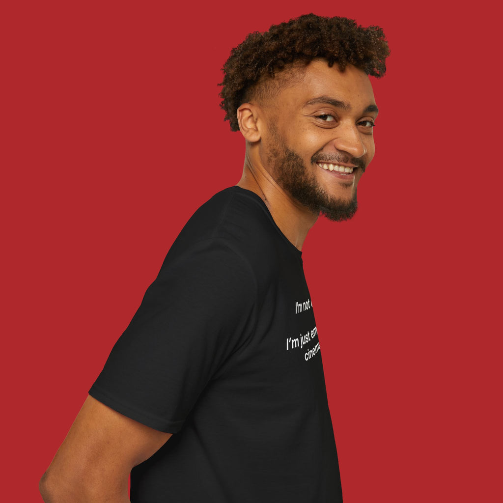 Black "I'm Not Dramatic, I'm Just Emotionally Cinematic" print t-shirt by Printify, featuring bold text design on front.