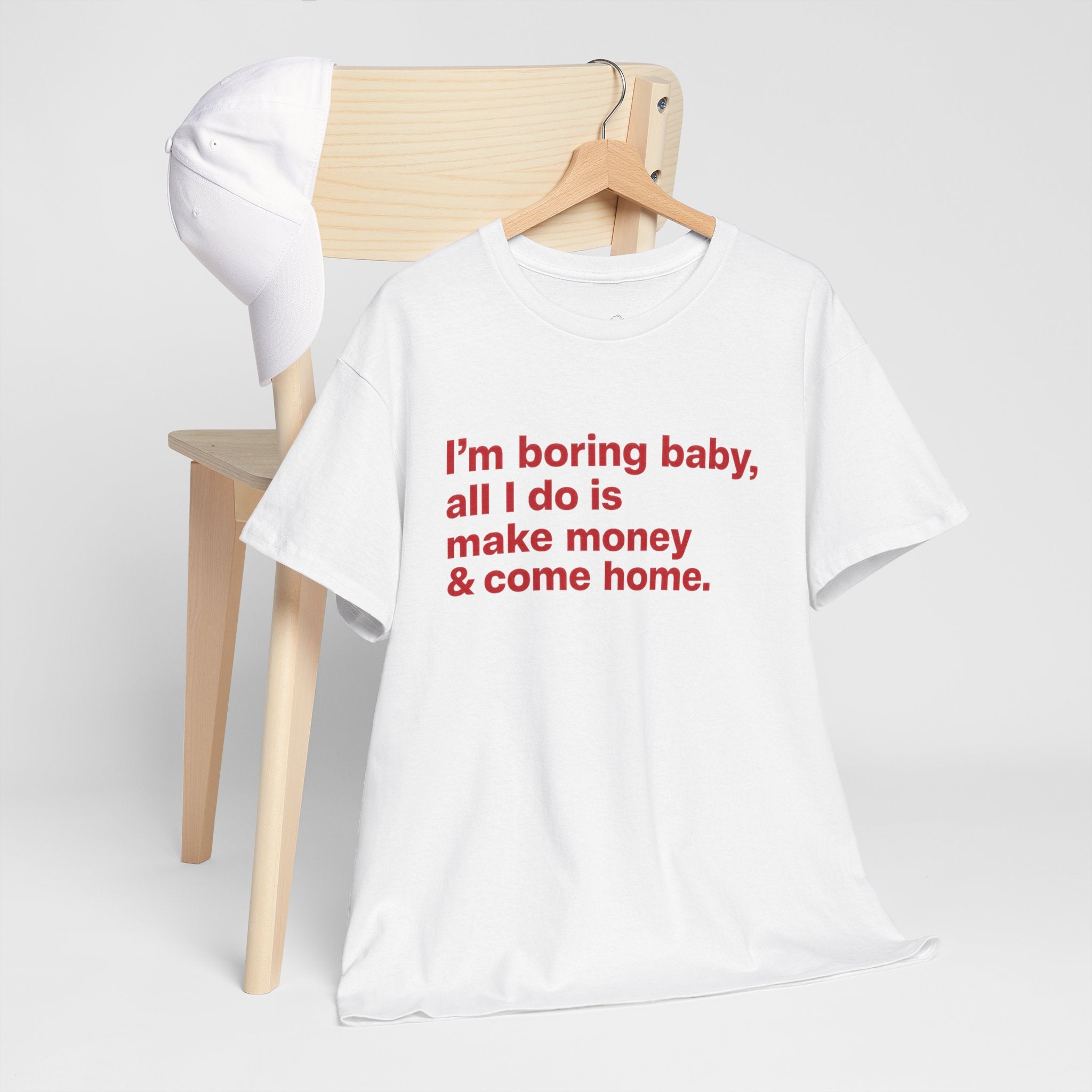 Unisex cotton T-shirt with humorous "I'm Boring Baby All I Do Is Make Money & Come Home" slogan, casual fit, Printify brand.