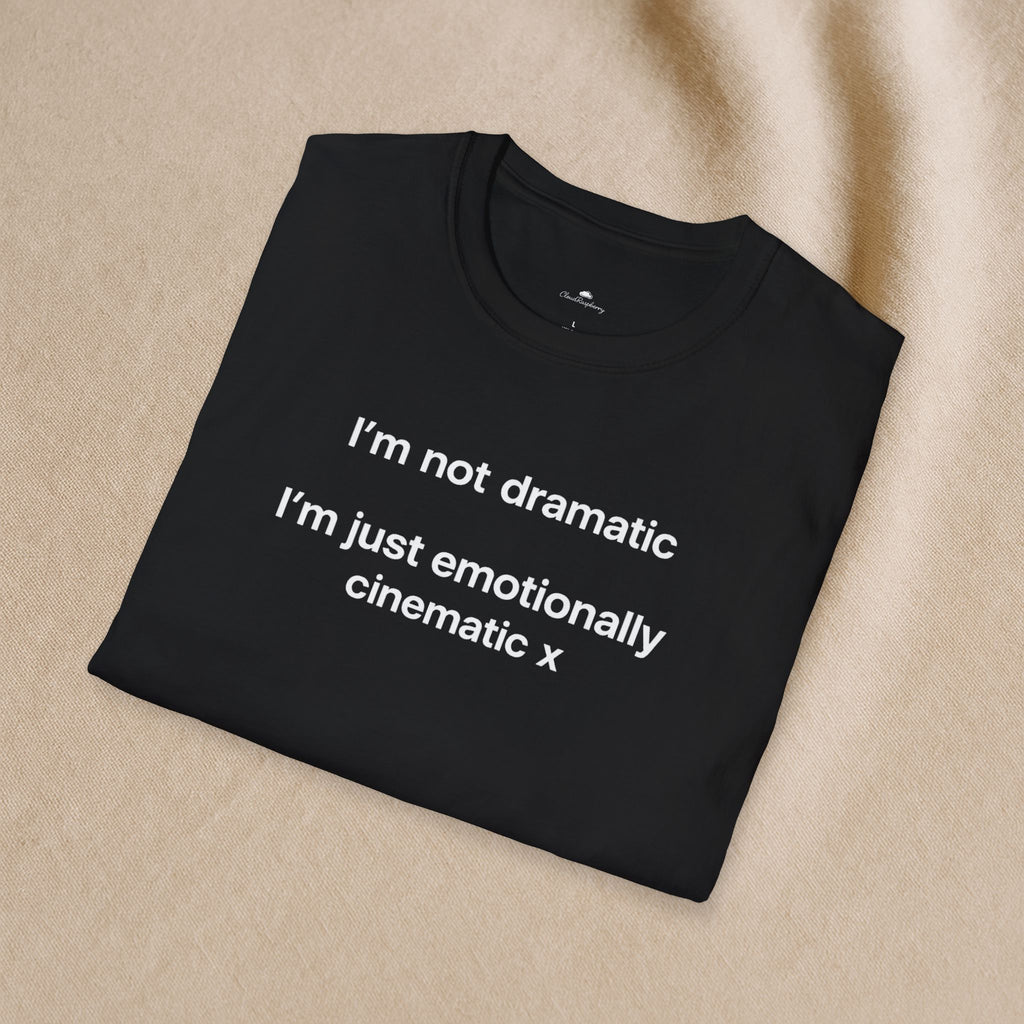 Light-colored "I'm Not Dramatic, I'm Just Emotionally Cinematic" T-shirt by Printify, displayed flat on a white background.