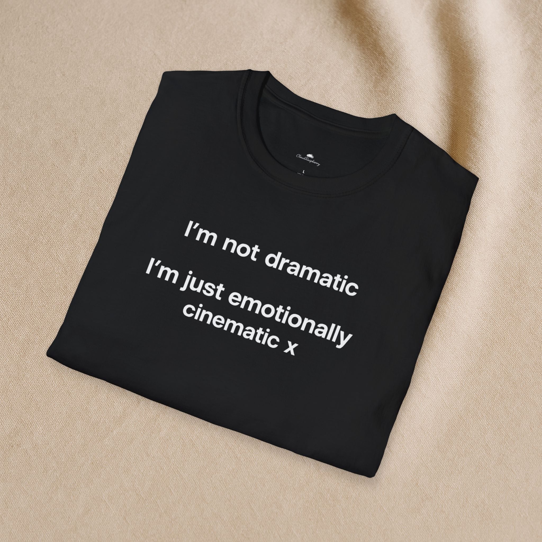 Light-colored "I'm Not Dramatic, I'm Just Emotionally Cinematic" T-shirt by Printify, displayed flat on a white background.