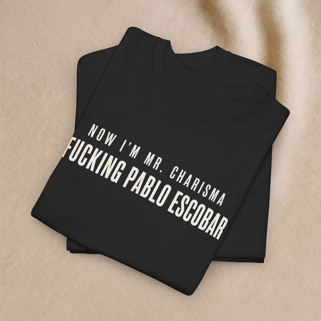 Black cotton T-shirt featuring bold white text "Now I'm Mr. Charisma Fucking Pablo Escobar" with Dracula lyrics design by Printify.
