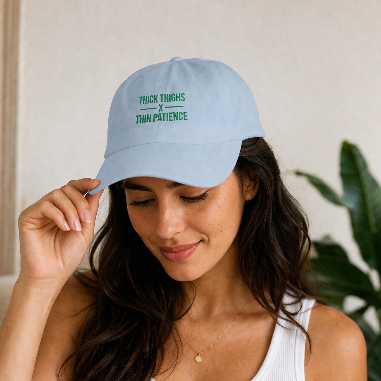 Cotton adjustable dad cap with embroidered "Thick Thighs x Thin Patience" slogan, featuring a classic hat design and curved brim.