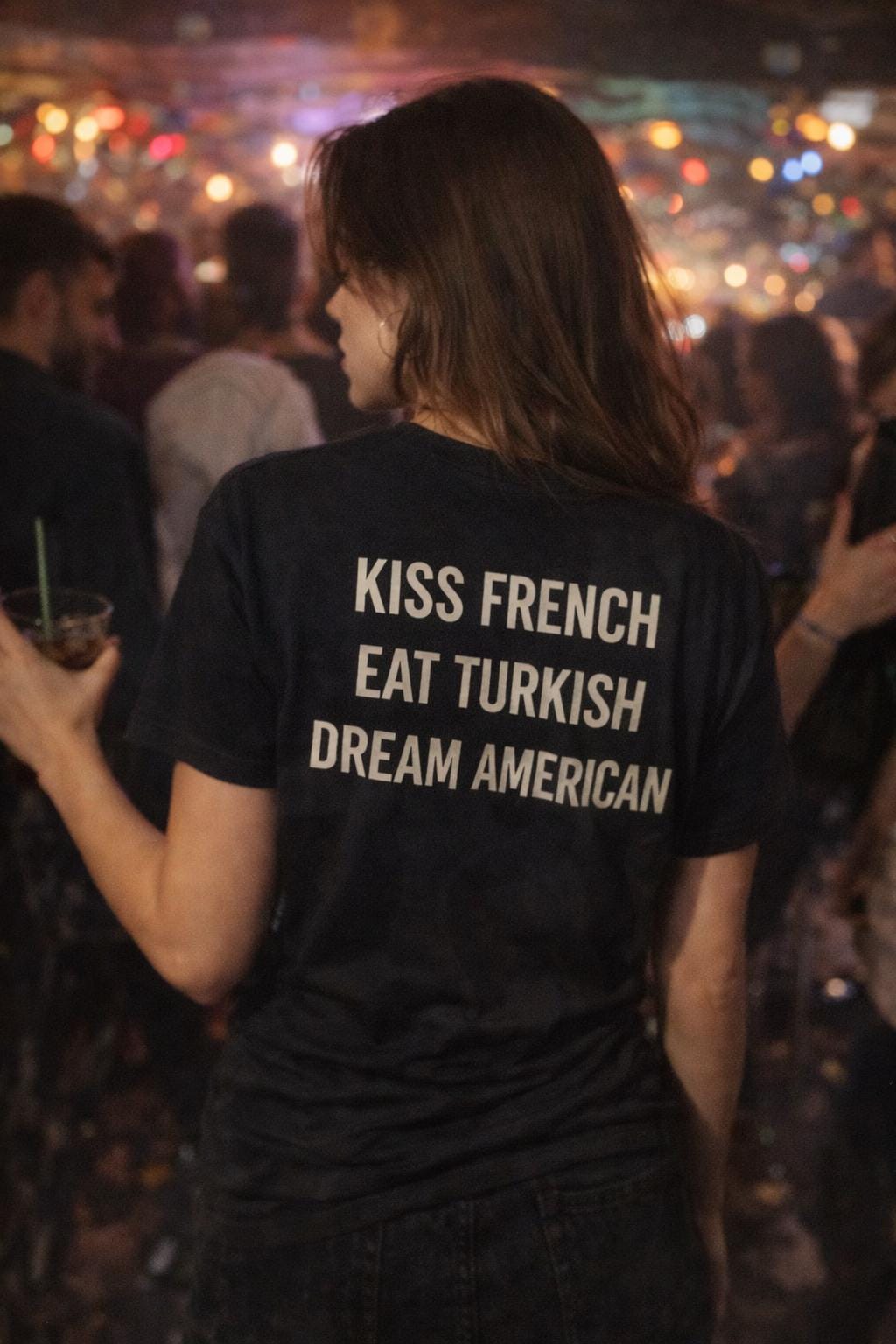 Unisex cotton T-shirt with printed "Kiss French, Eat Turkish, Dream American" slogan, featuring international couple design.