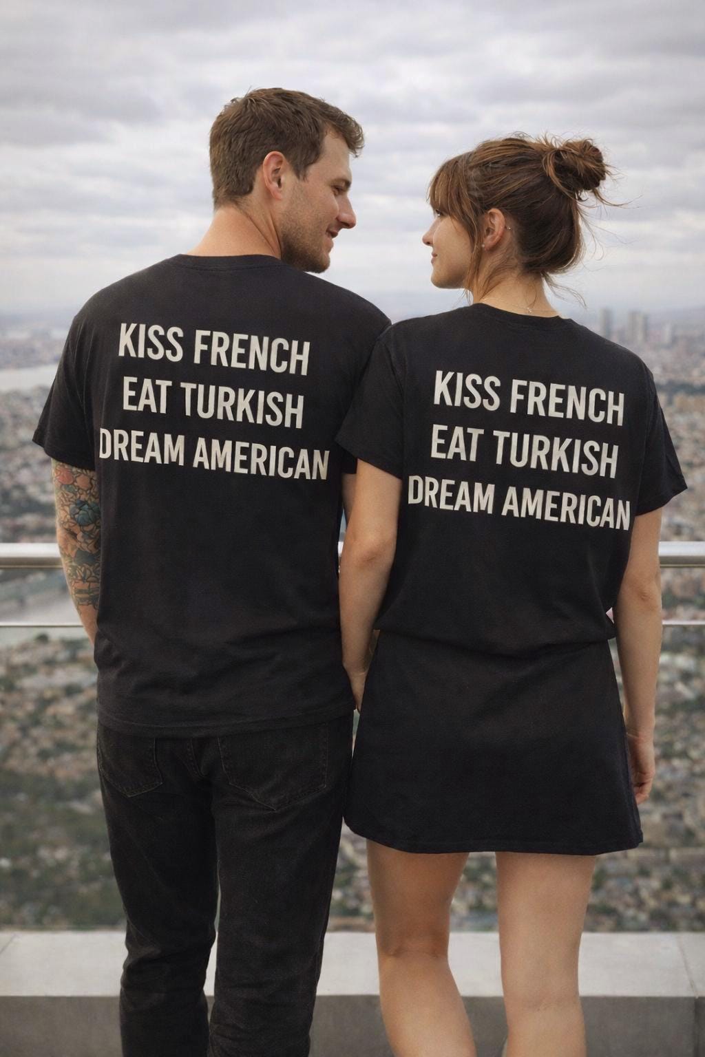 Unisex cotton T-shirt with "Kiss French, Eat Turkish, Dream American" print, featuring international couple design and casual style.