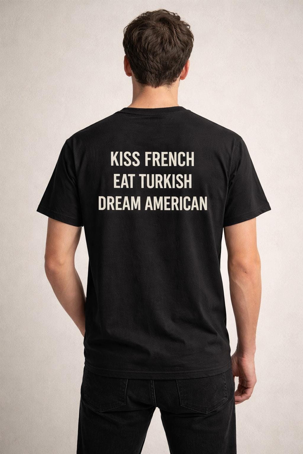 Unisex cotton T-shirt with "Kiss French, Eat Turkish, Dream American" print, featuring an international couple design.
