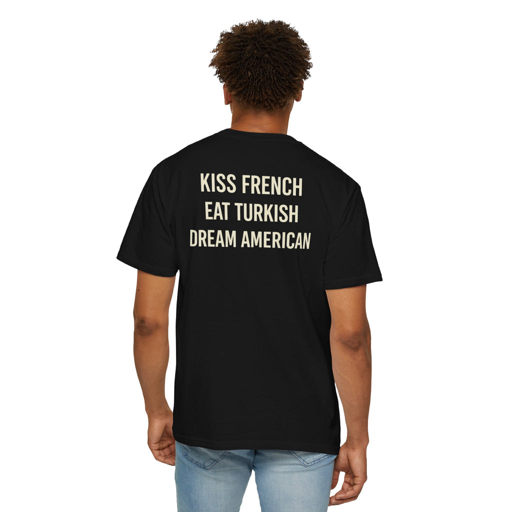 Unisex cotton T-shirt with "Kiss French, Eat Turkish, Dream American" print, featuring international couple design in vibrant colors.