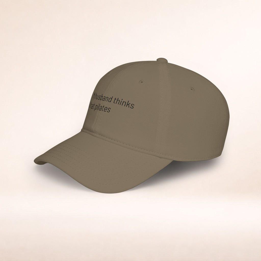 Black low profile baseball cap with embroidered humorous text "My Husband Thinks I'm At Pilates" by Printify, casual accessory.