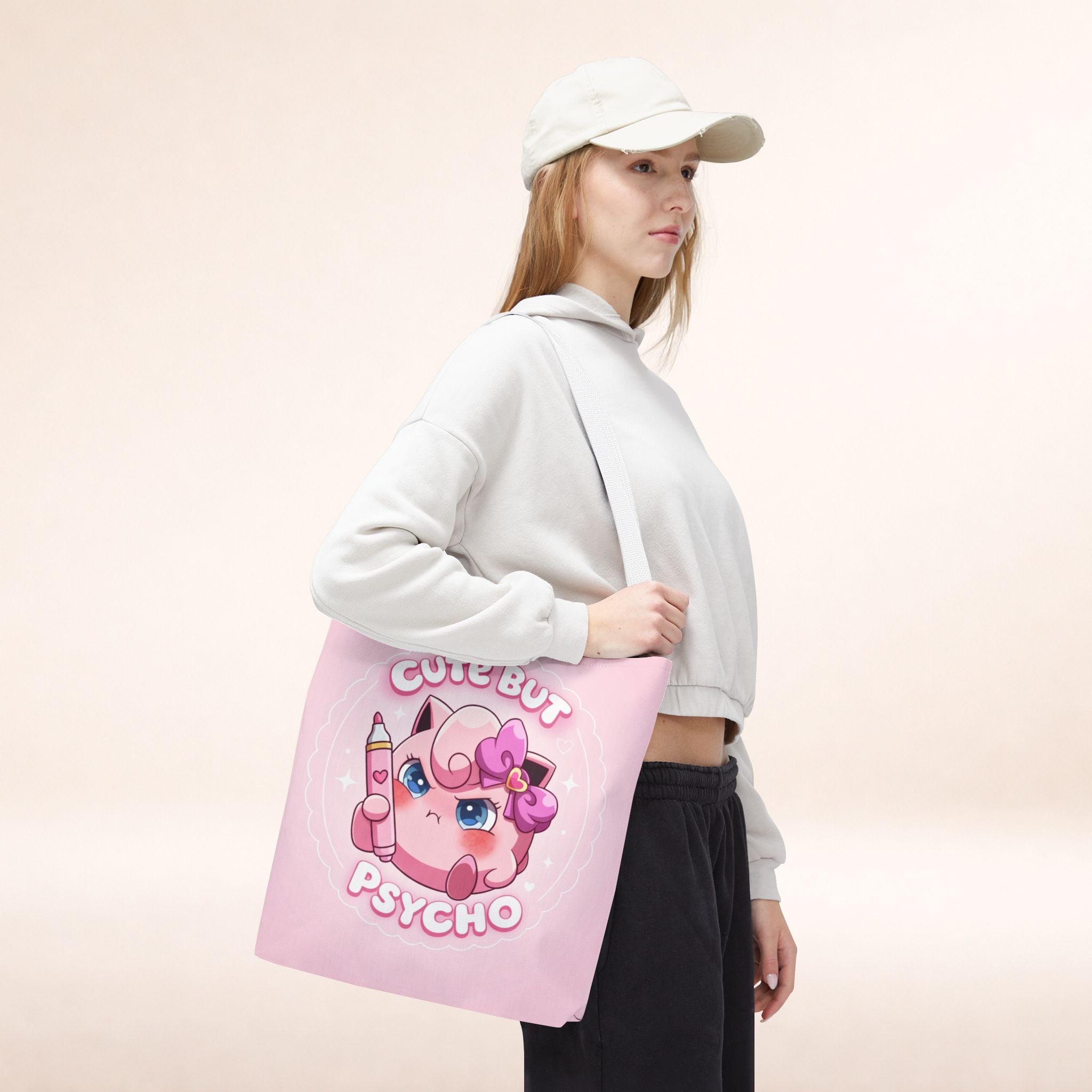 Pink "Cute But Psycho" tote bag by Printify featuring kawaii design, sturdy fabric, and spacious interior for everyday use.