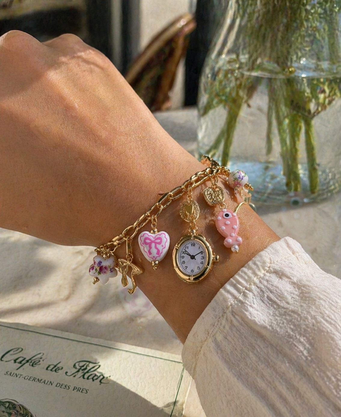 Pink ceramic coquette watch charm necklace and bracelet set with gold floral fish and bow designs by CloudRaspberry Studio.