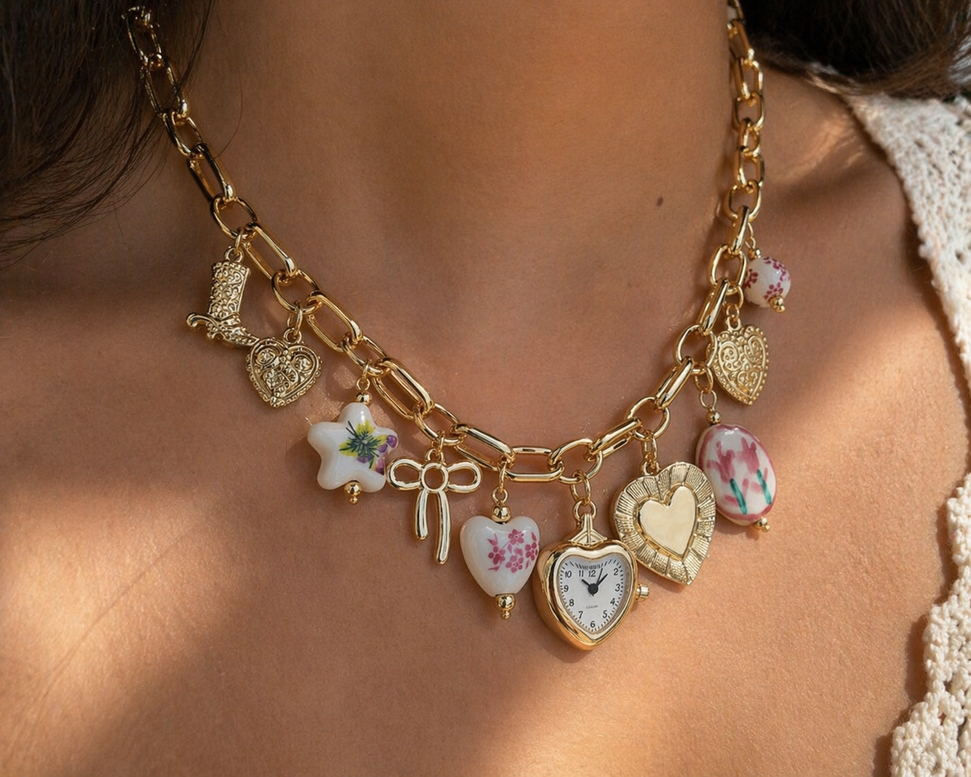 Pink ceramic and floral heart necklace by CloudRaspberry Studio featuring gold-tone charms, perfect for boho jewelry styling.