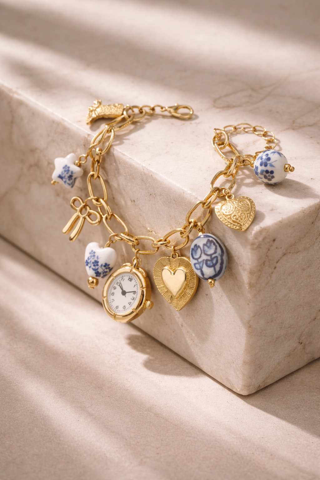 Blue ceramic faux watch charm necklace by CloudRaspberry Studio featuring gold porcelain accents, styled with matching bracelet.