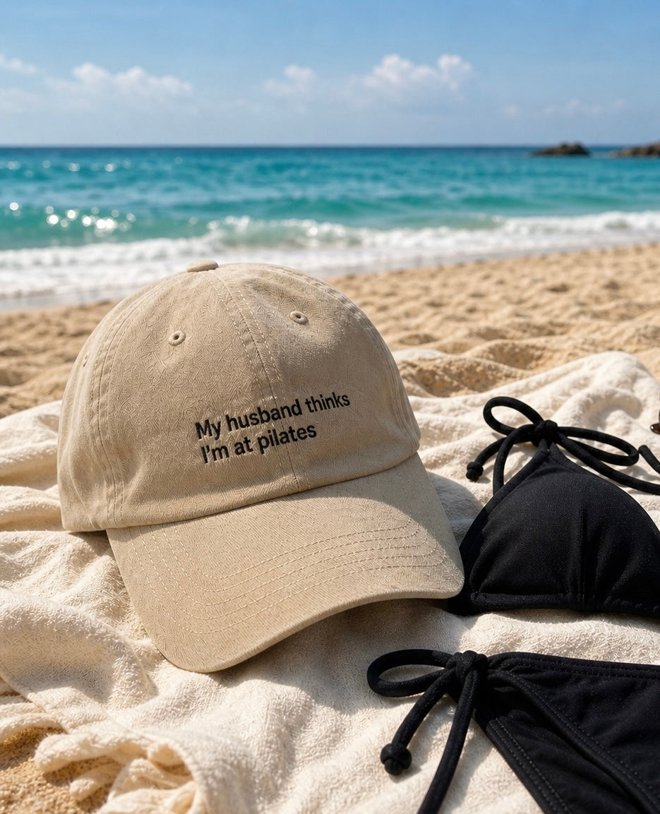 Premium embroidered Printify baseball cap featuring humorous "My Husband Thinks I'm At Pilates" design, low profile style.