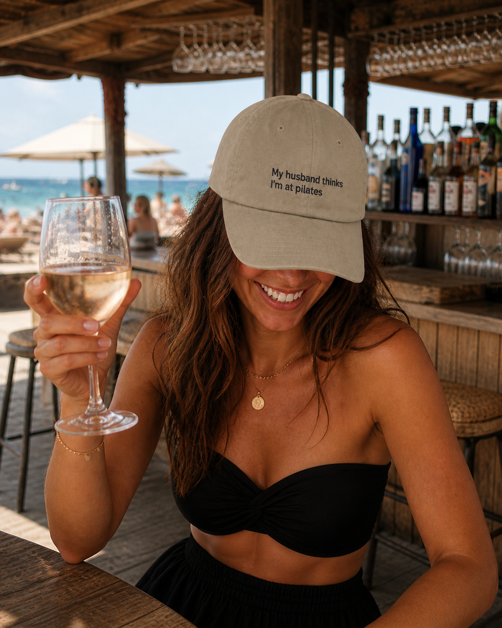 Premium embroidered baseball cap with humorous "My Husband Thinks I'm At Pilates" slogan, low profile design, by Printify