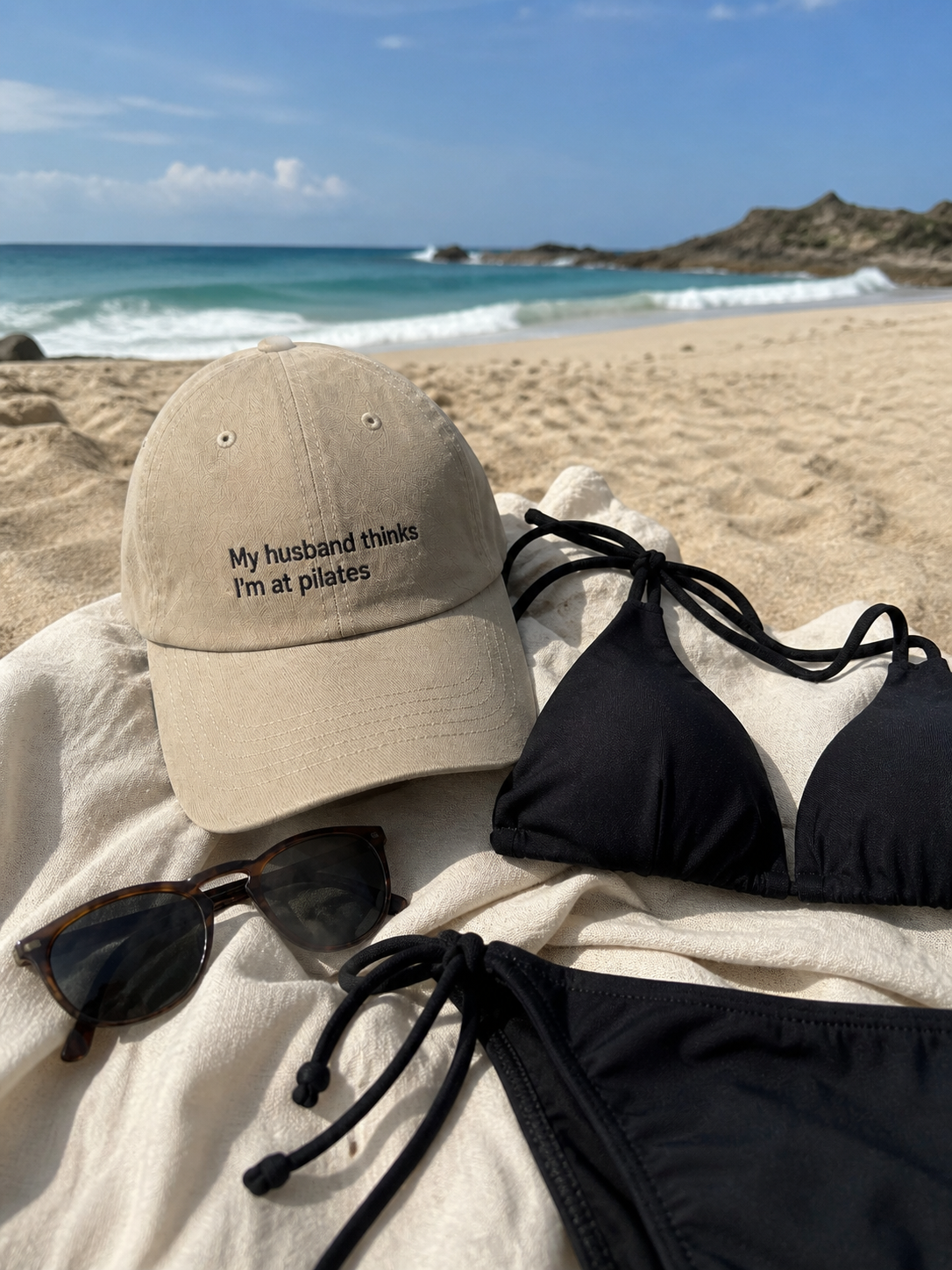 Black low-profile baseball cap with embroidered text "My Husband Thinks I'm At Pilates," stylish and humorous men's hat by Printify.