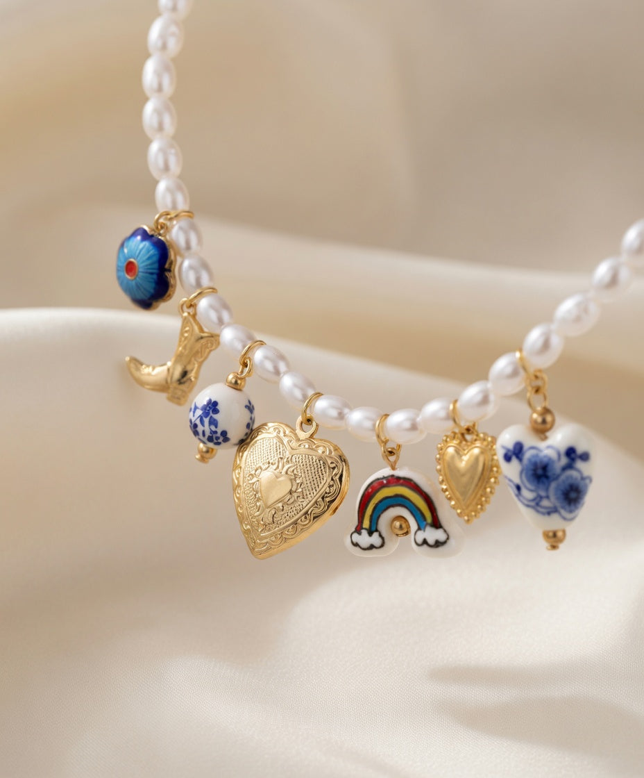 Blue floral cowboy charm necklace by CloudRaspberry Studio featuring pearl and ceramic charms, perfect for boho jewelry styles.
